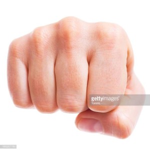 Close-up of a male fist. Front view isolated on white.